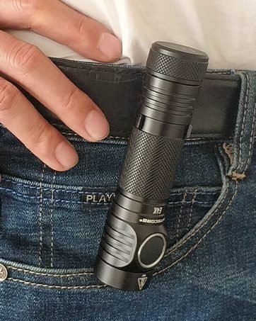 flashlight clipped to a belt on a pair of jeans